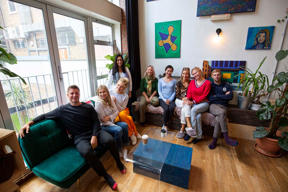 A group of guests photographed together on the sofas after an event