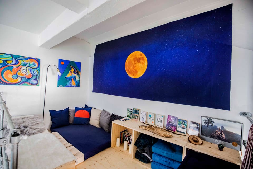 The moon mural above the blue daybed in the quiet room
