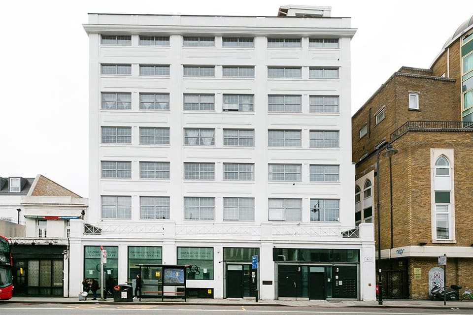 The white brick facade of 222 Kingsland Road seen from the street