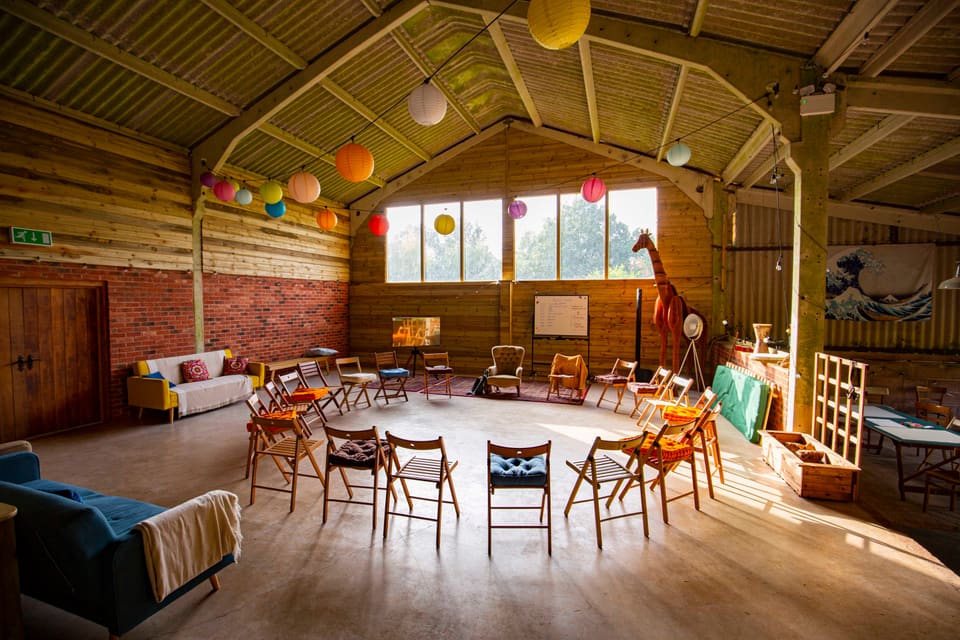 The barn at Selgars Mill set with a circle of chairs for a workshop