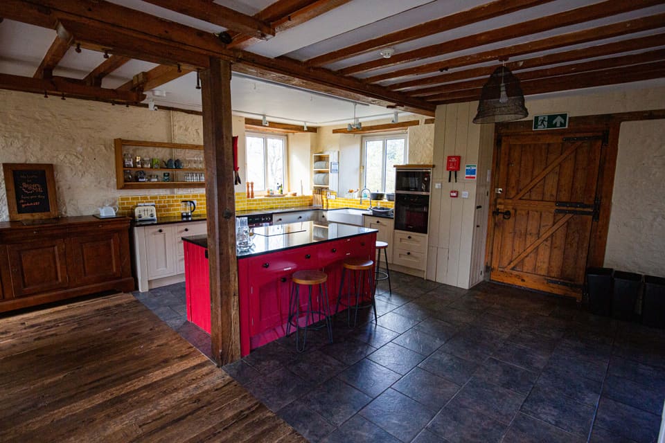 The Selgars Mill kitchen with its red island and breakfast stools